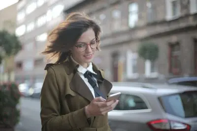 business woman using mobile app happily